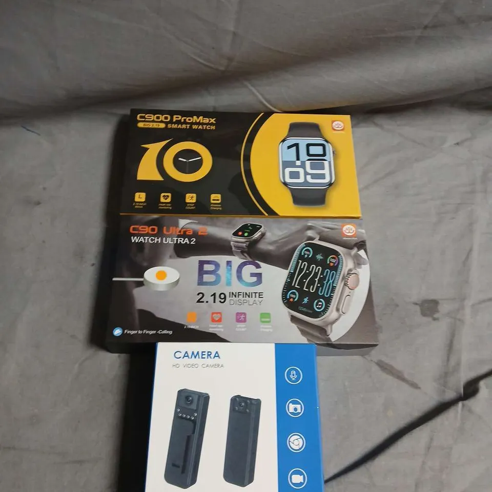 BOX OF ASSORTED ITEMS TO INCLUDE C90 PROMAX SMART WATCH & C90 ULTRA 2 SMART WATCH WITH A8/A9 VIDEO CAMERA ACCESSORIES