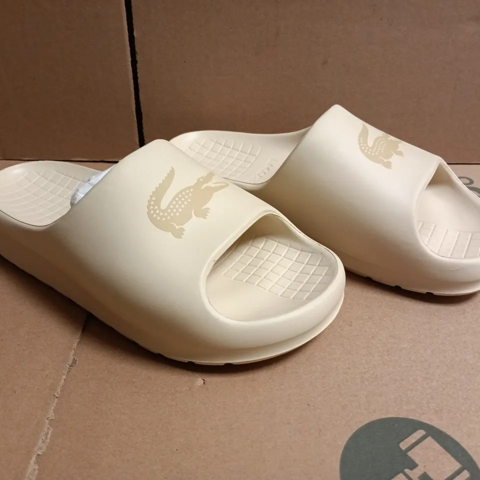 PAIR OF LACOSTE SERVE SLIDES IN CREAM SIZE UK 5