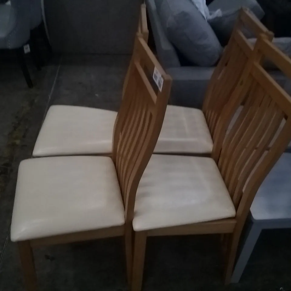 APPROXIMATELY 4 OAK EFFECT SLATTED BACK DINING CHAIRS WITH CREAM FAUX LEATHER SEAT PADS