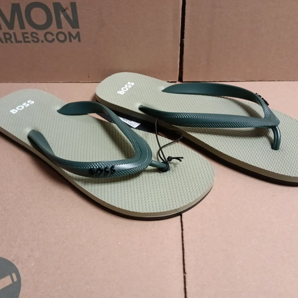 BOXED PAIR OF BOSS TRACY LOGO FLIP FLOPS IN LIGHT GREEN SIZE 7