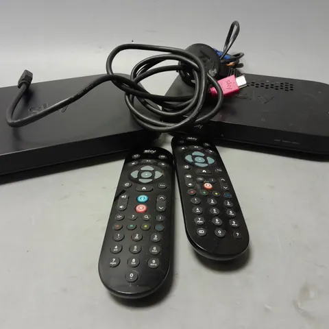 4 SKY ROUTERS AND BOXES WITH REMOTES AND CABLES