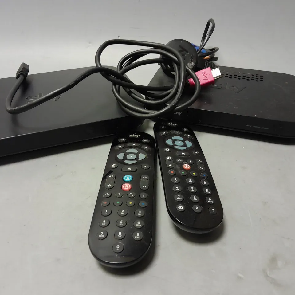 4 SKY ROUTERS AND BOXES WITH REMOTES AND CABLES