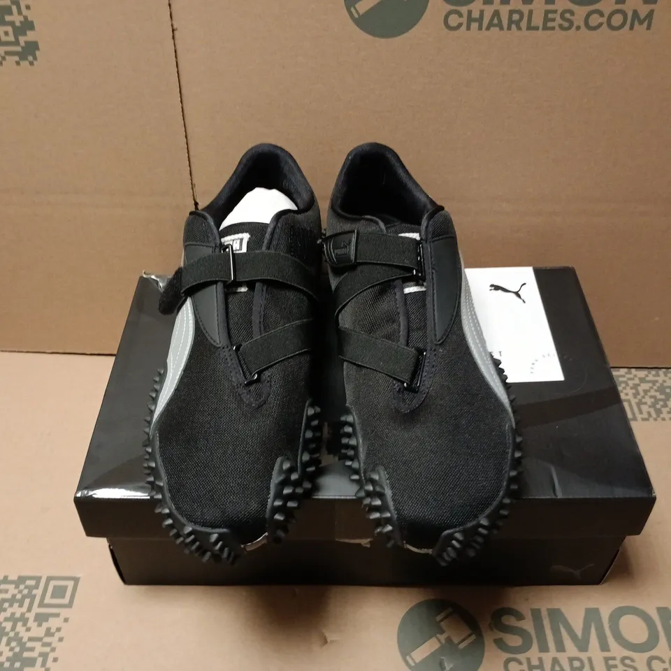 BOXED PAIR OF PUMA MOSTRO OG TRAINERS IN BLACK - UK 12