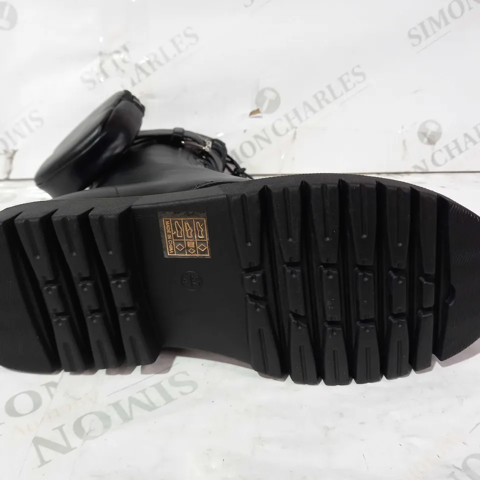 BOXED PAIR OF PRETTY LITTLE THING LEATHER BOOTS IN BLACK UK SIZE 4