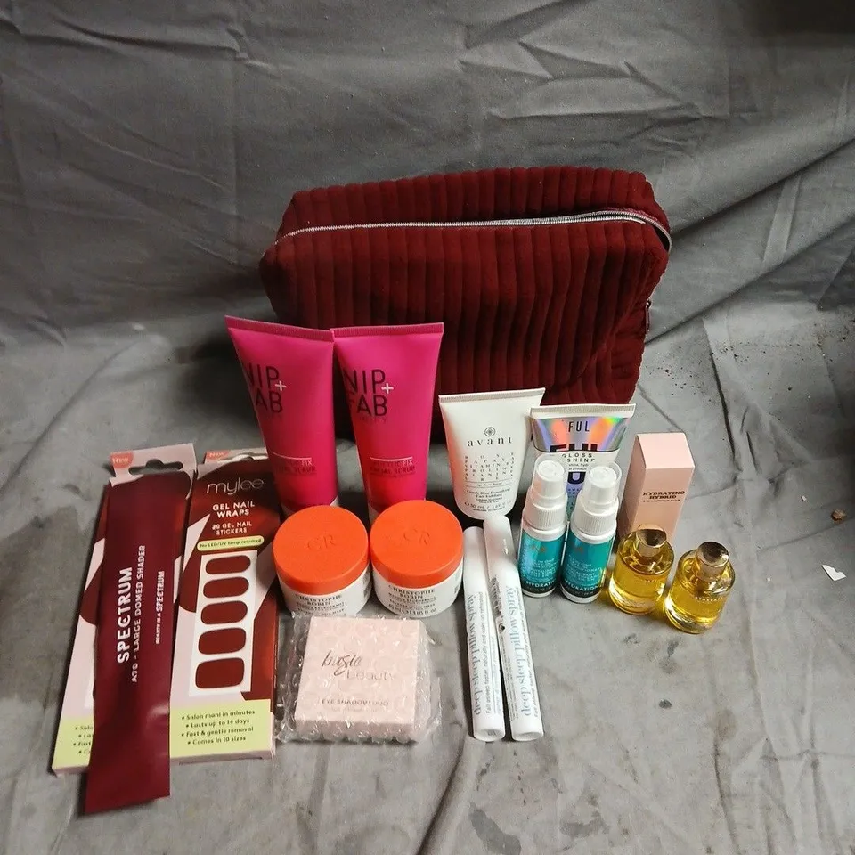 GLOSSYBOX APPROXIMATELY 15 ASSORTED BATH, BODY AND BEAUTY PRODUCTS WITH A BURGUNDY POUCH