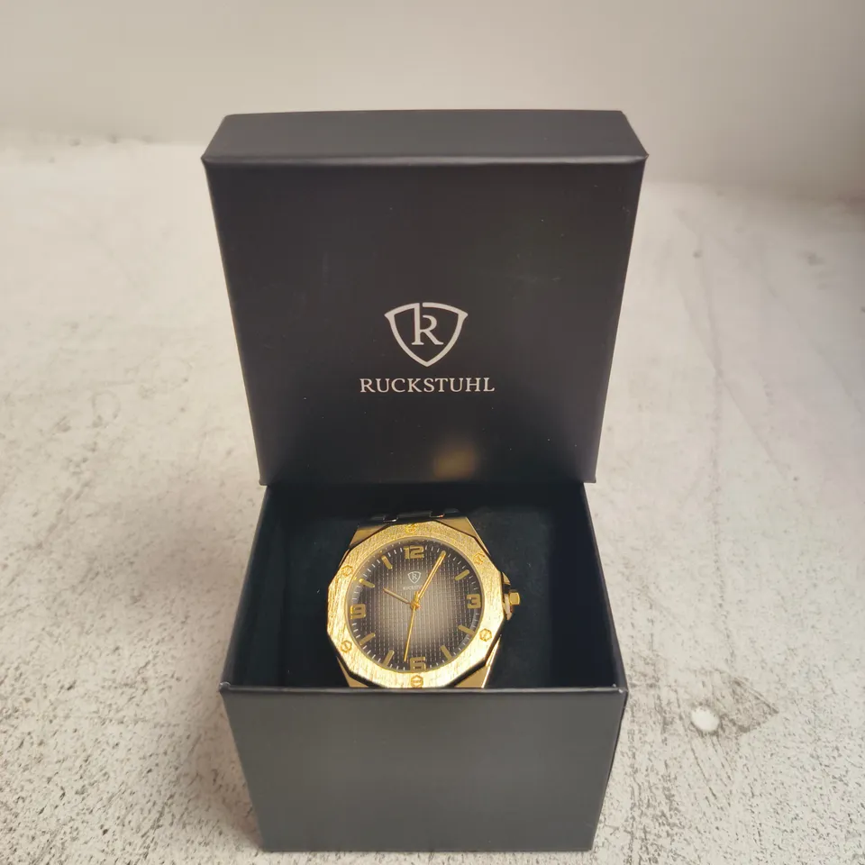 RUCKSTUHL GOLD-TONE WRISTWATCH – BLACK DIAL, RUBBER STRAP