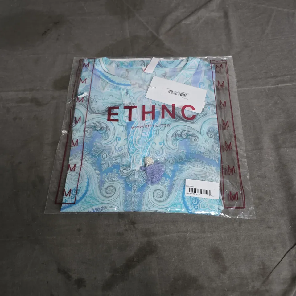 ETHNC Scarf in turquoise paisley pattern – brand label on packaging