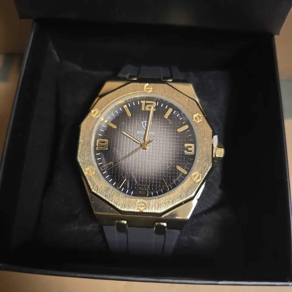 RUCKSTUHL BLACK RUBBER STRAP WRISTWATCH WITH GOLD COLOUR FRAME AND BLACK/SILVER COLOUR FACE