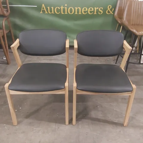 PAIR OF MAGNUS DINING CHAIRS - BLACK PU FAUX LEATHER SEAT - NATURAL ASH FRAME