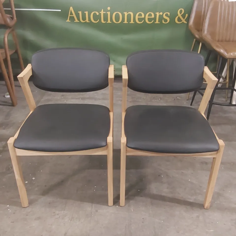 PAIR OF MAGNUS DINING CHAIRS - BLACK PU FAUX LEATHER SEAT - NATURAL ASH FRAME