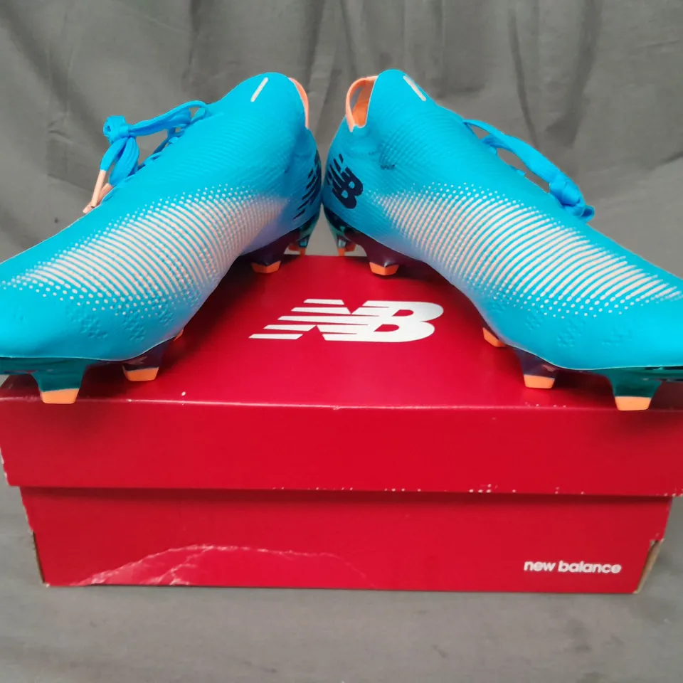 BOXED PAIR OF NEW BALANCE FURON FOOTBALL BOOTS IN SKY BLUE/ORANGE UK SIZE 10.5