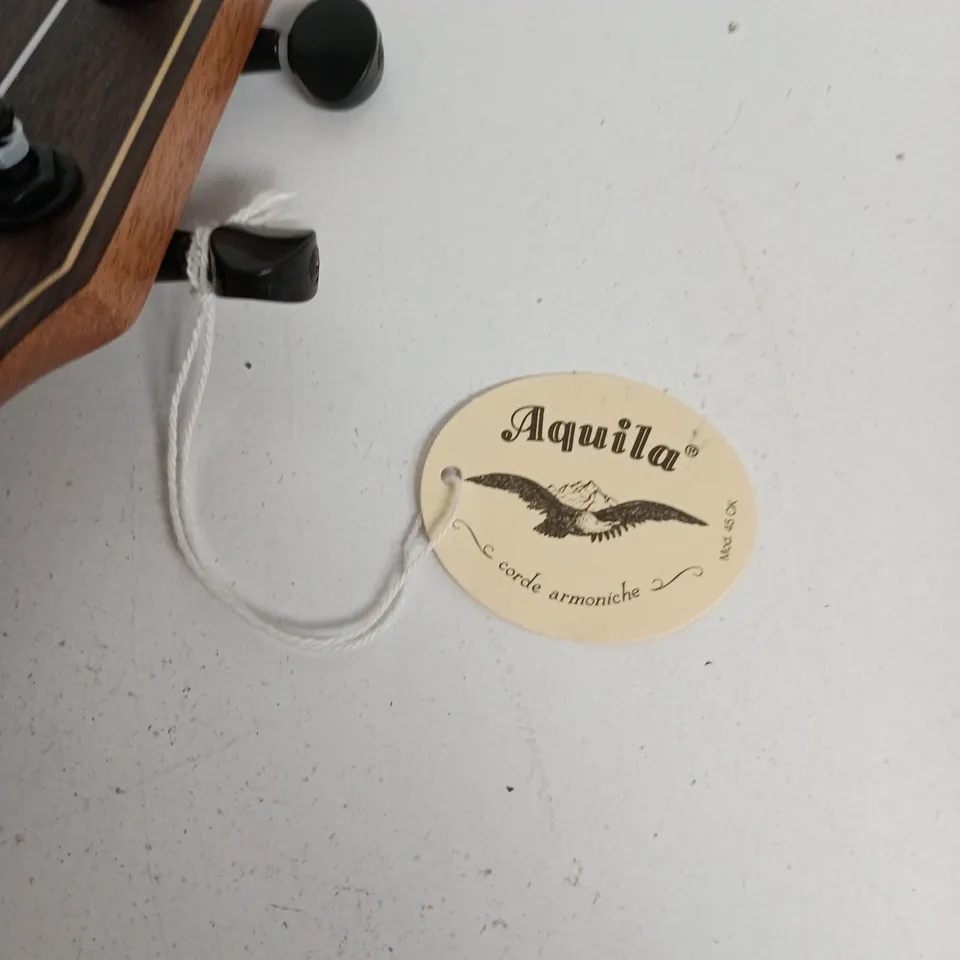UKULELE – NATURAL FINISH, FOUR NYLON STRINGS; AQUILA TAG ATTACHED