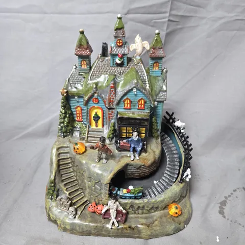 CERAMIC HALLOWEEN HAUNTED HOUSE SCENE WITH FIGURES AND CIRCULAR TRACK