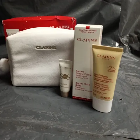 CLARINS PARIS SKINCARE GIFT SET WITH WHITE POUCH; INCLUDES SERUM, BEAUTÉ ÉCLAIR BALM AND HYDRATING CLEANSER