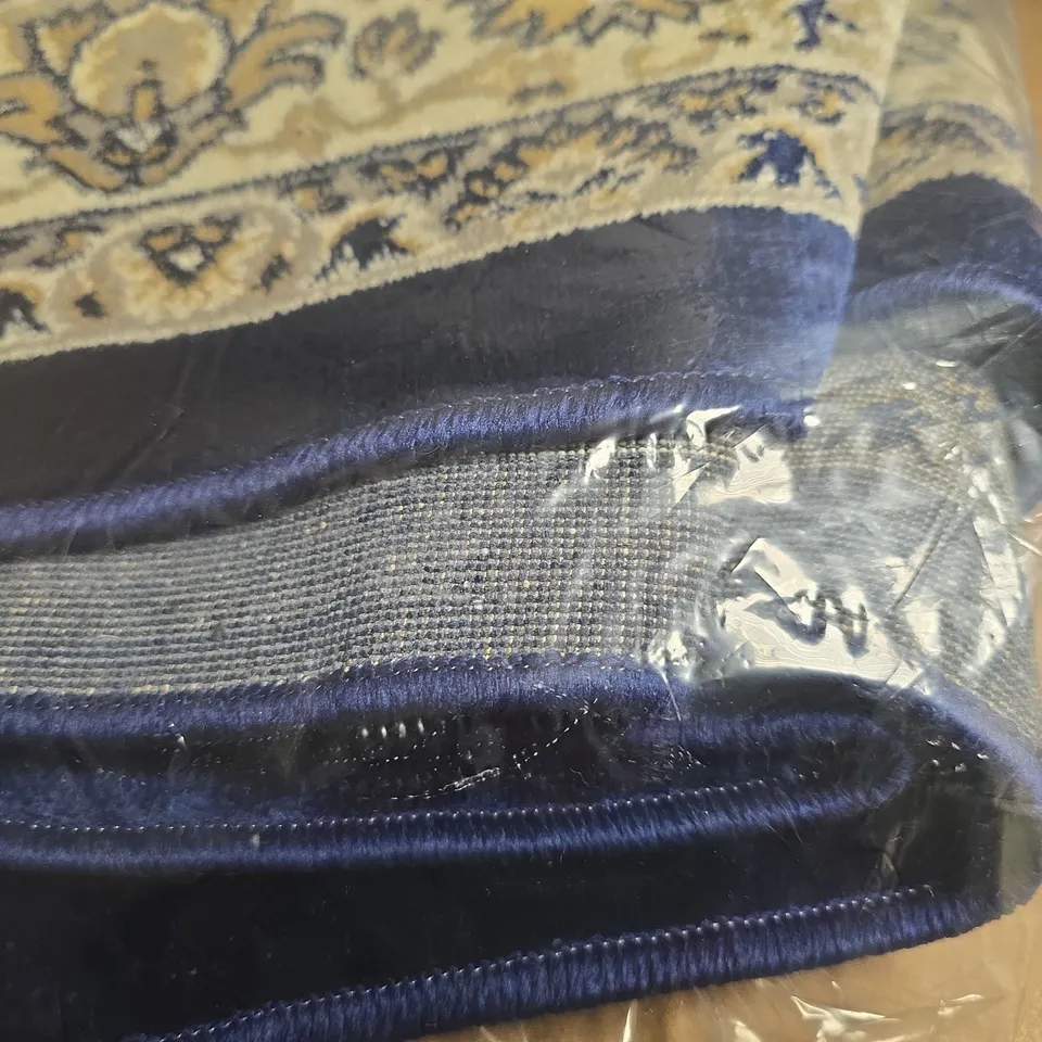 PATTERN OVER BLUE RUG - SIZE UNSPECIFIED