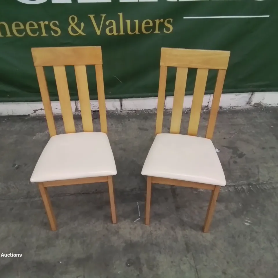 A PAIR OF DESIGNER LEATHER UPHOLSTERED HARD BACK DINNING CHAIRS