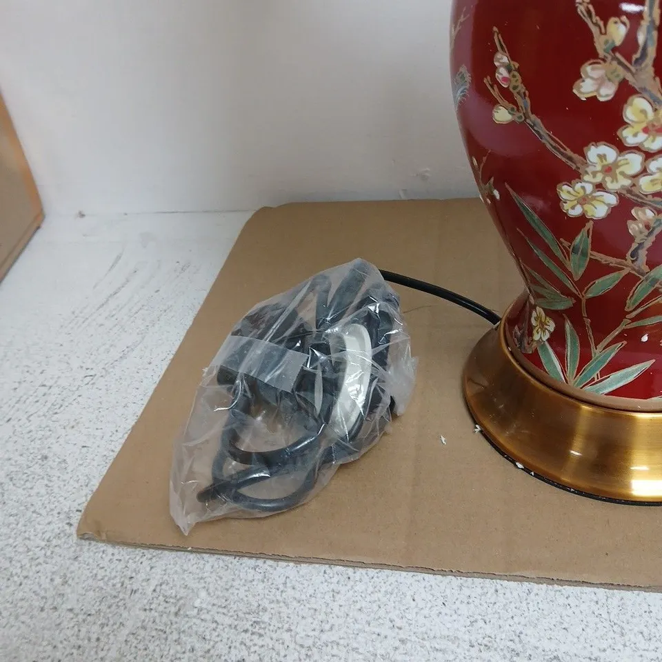 PORCELAIN TABLE LAMP WITH RED GLAZE, BIRD & BLOSSOM MOTIF; BRASS BASE; FABRIC SHADE