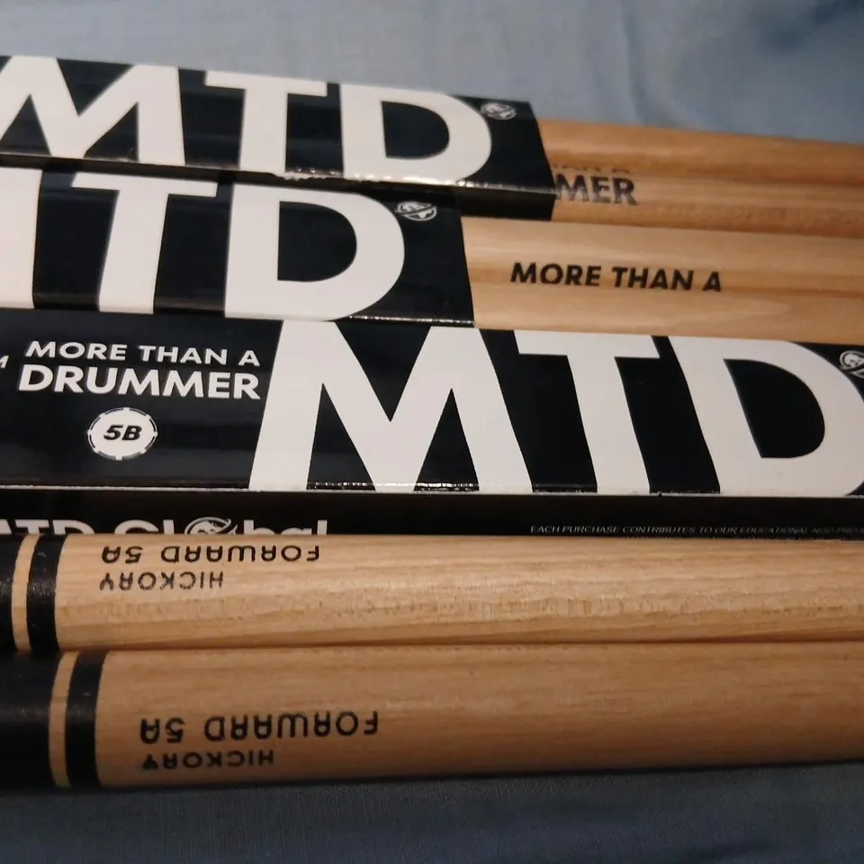 FOUR SETS OF DRUM STICKS TO INCLUDE; PRO-MARK HICKORY FORWARD 5A DRUMSTICKS AND MTD (MORE THAN A DRUMMER) 5B