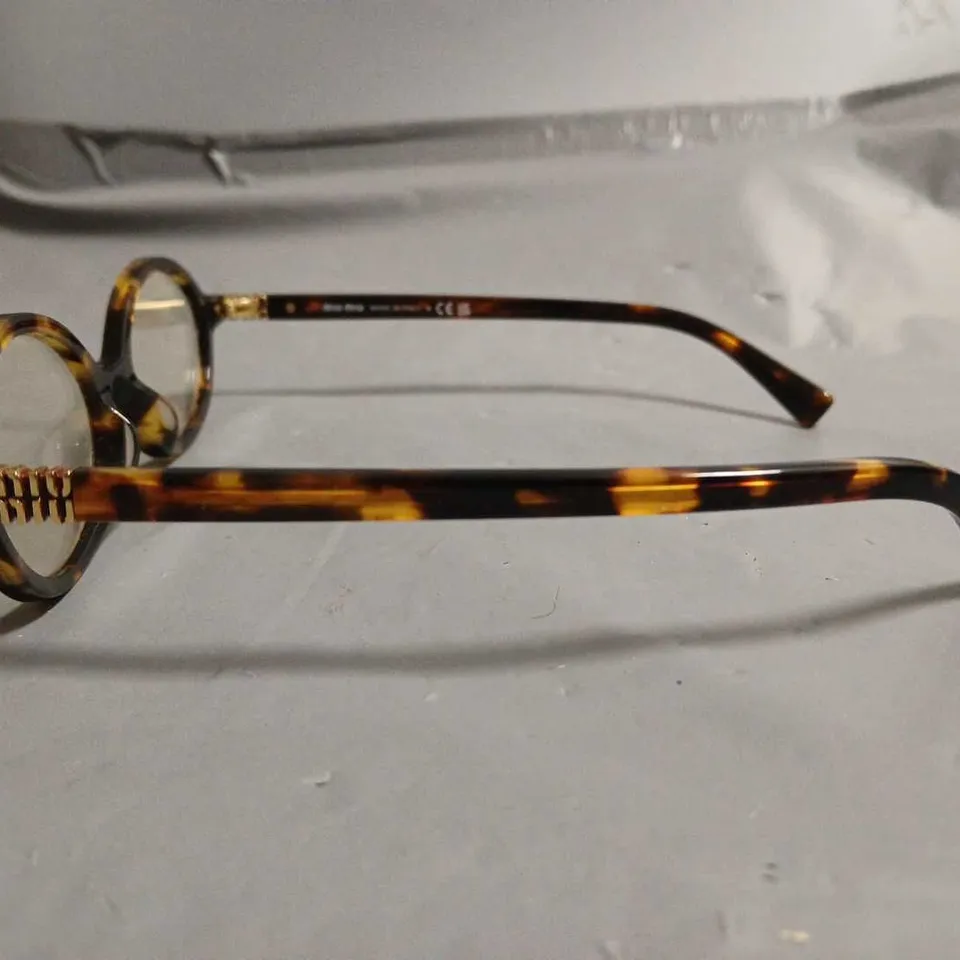 BOXED PAIR OF MIU MIU BROWN PATTERENED GLASSES