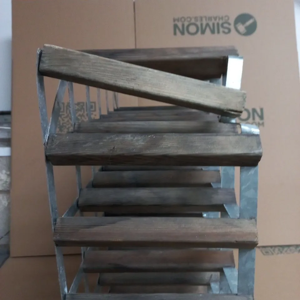 WINE RACK WITH A LIKELY 42-BOTTLE CAPACITY UNIT WITH WEATHERED WOOD AND RIVETED METAL FRAME