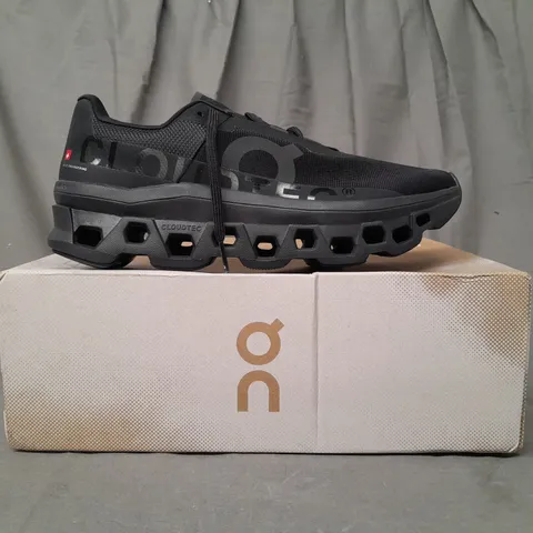 BOXED PAIR OF ON RUNNING CLOUDMONSTER TRAINERS IN BLACK UK SIZE 9