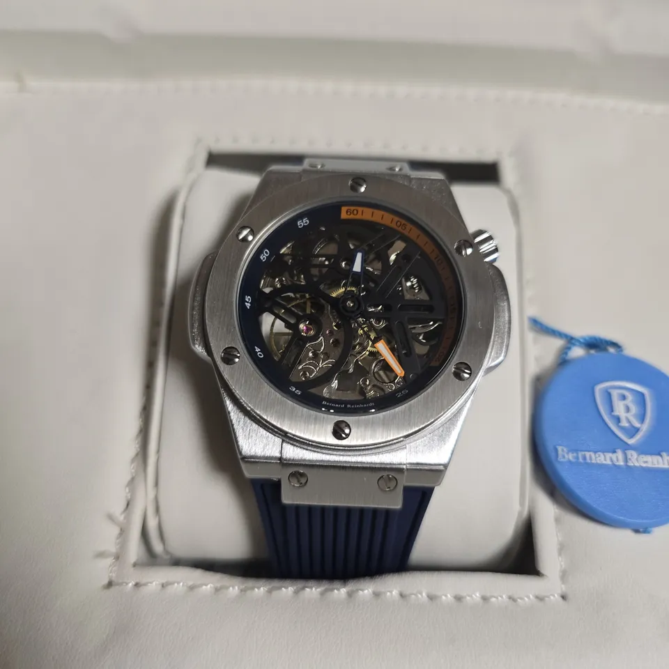 MENS BERNARD REINHARDT MECHANICAL SKELETON WATCH WITH BLUE RUBBER STRAP