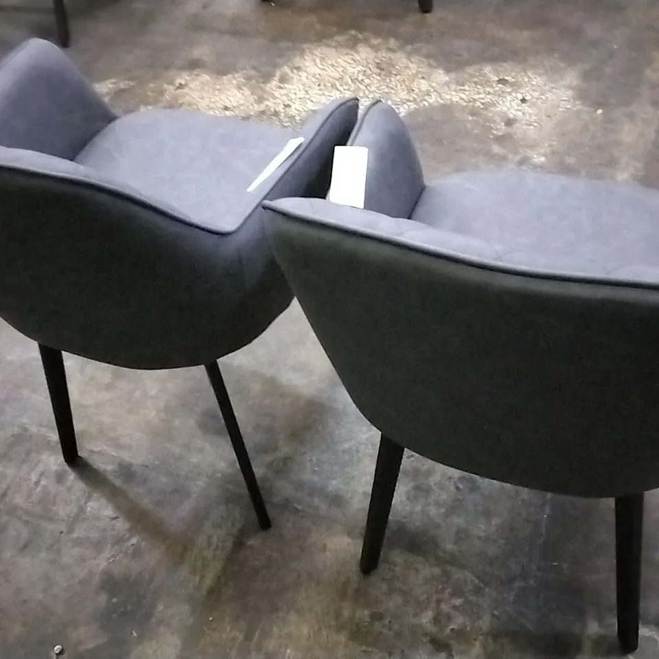 DESIGNER PAIR OF GREY LEATHER PILLOWED DINING CHAIRS WITH ARMREST AND BLACK LEGS