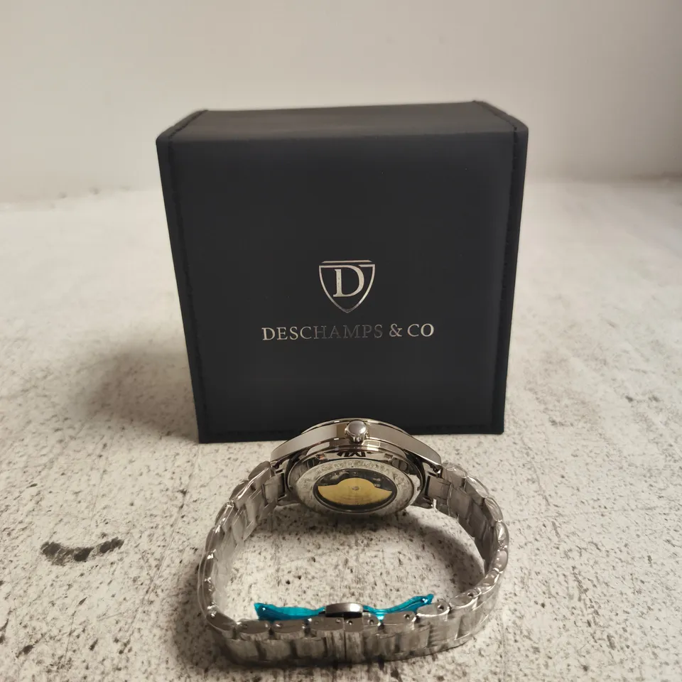 WRISTWATCH WITH SKELETON DIAL IN DESCHAMPS & CO PRESENTATION BOX, STAINLESS STEEL BRACELET