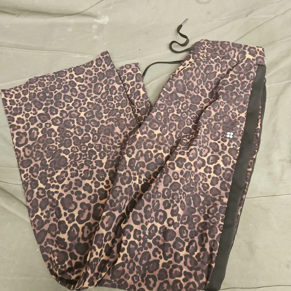 SWEATY BETTY EXPLORER WIDE LEG TAPED 32" TROUSERS IN BROWN WILD LEOPARD PRINT - MEDIUM