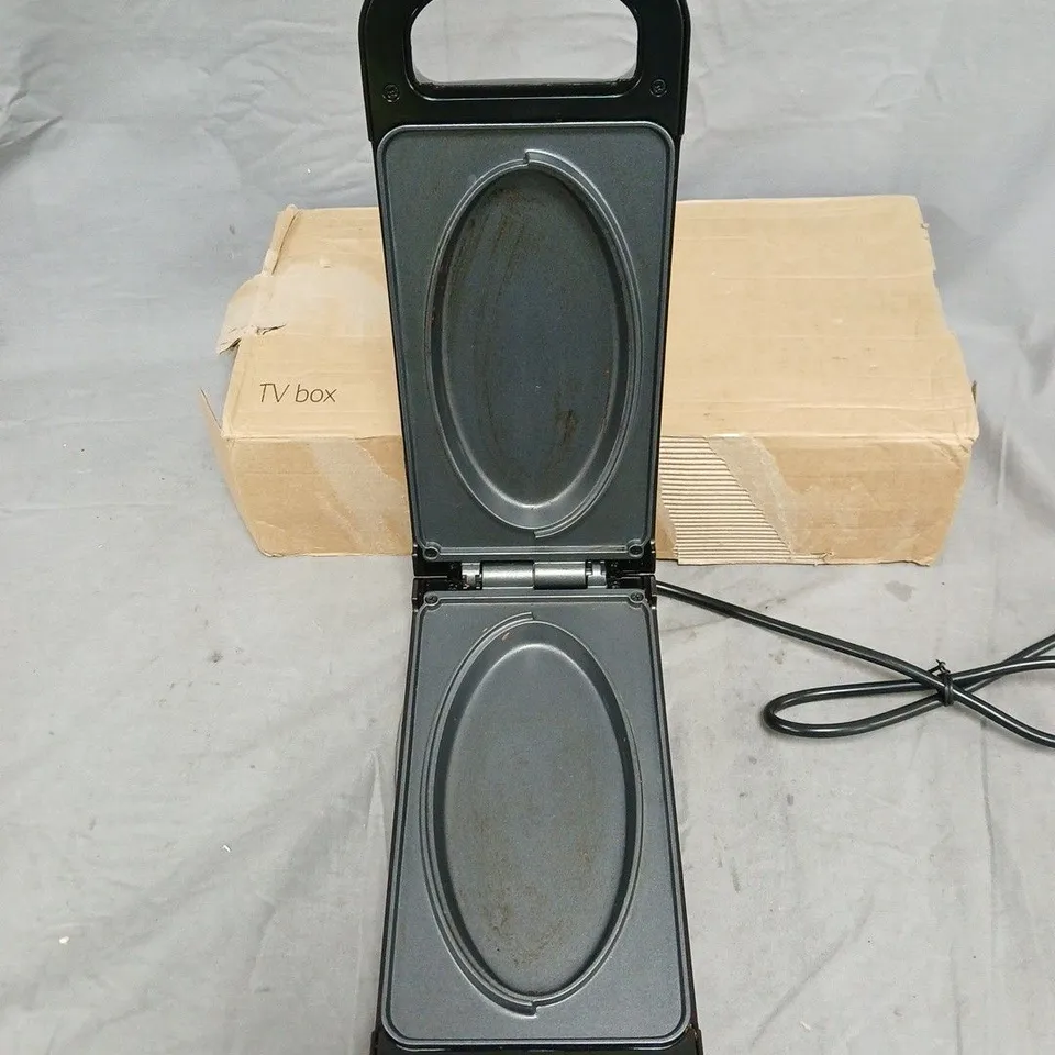 DREW & COLE ELECTRIC APPLIANCE – BLACK HANDHELD UNIT WITH DUAL OVAL HEATING SURFACES .