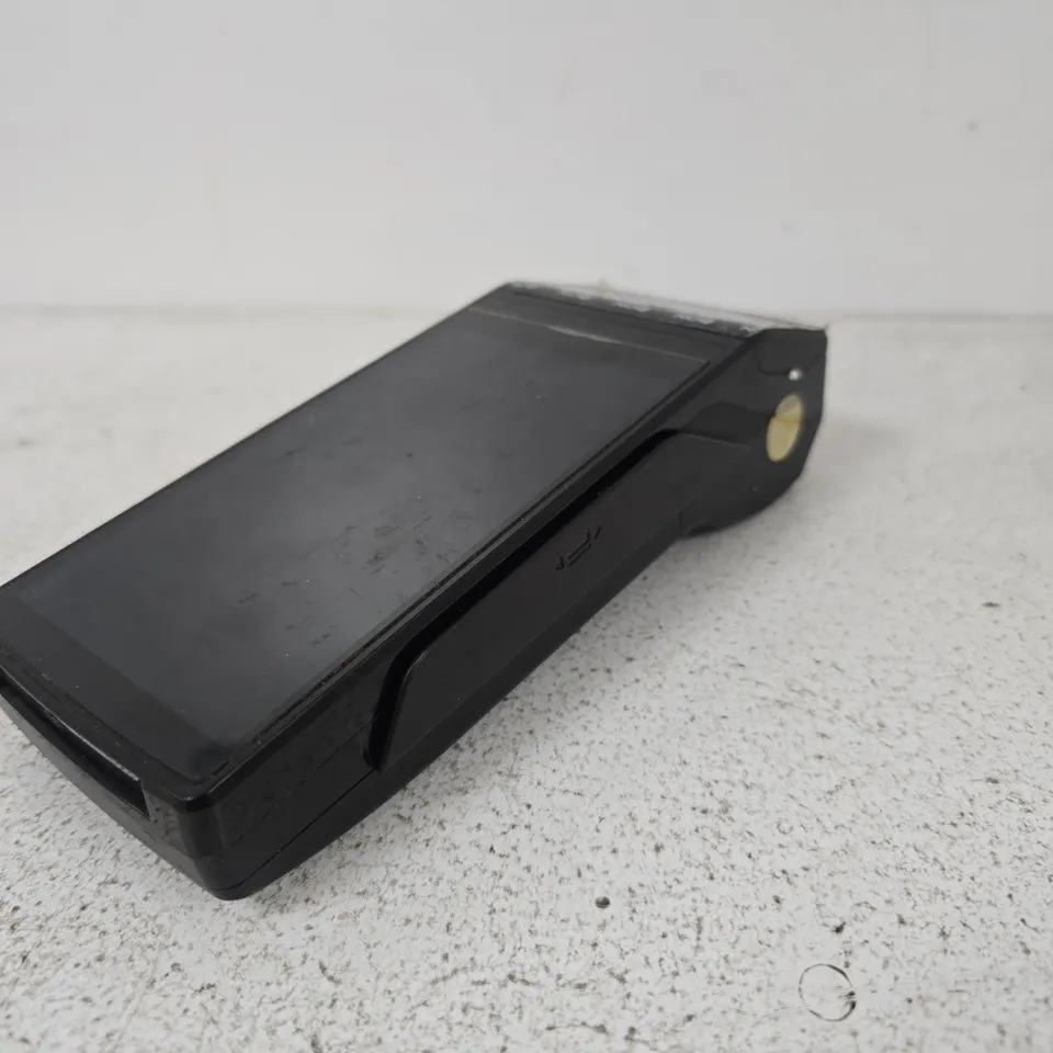 BLACK HANDHELD CARD MACHINE – APPEARS TO BE A DOCKING CRADLE OR ADAPTER