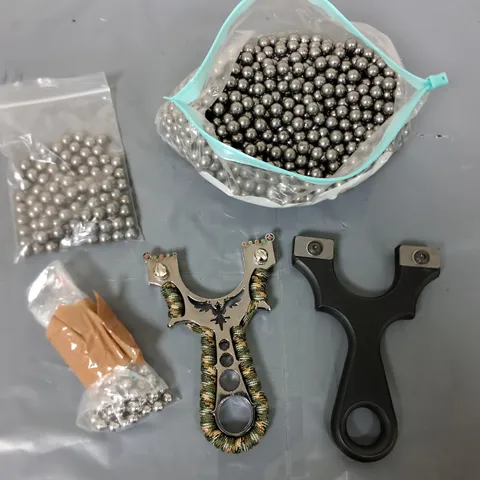 LOT OF METAL BALL BEARINGS AND TWO CATAPULTS 