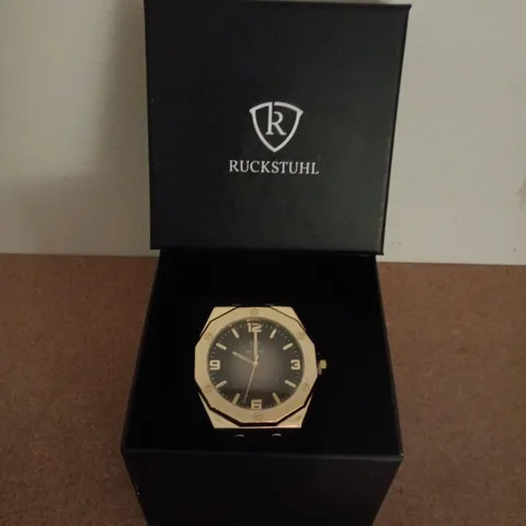 RUCKSTUHL GOLD COLOUR WRISTWATCH WITH BLACK RUBBER STRAP