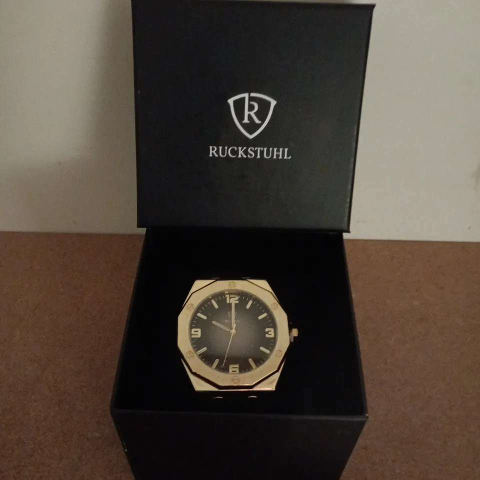 RUCKSTUHL GOLD COLOUR WRISTWATCH WITH BLACK RUBBER STRAP