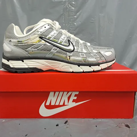 BOXED PAIR OF NIKE P-6000 TRAINERS IN METALLIC SILVER UK SIZE 8.5