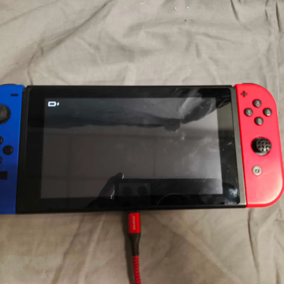 NINTENDO SWITCH CONSOLE WITH BLUE/RED JOY-CONS AND ISLAND ARTWORK SKIN