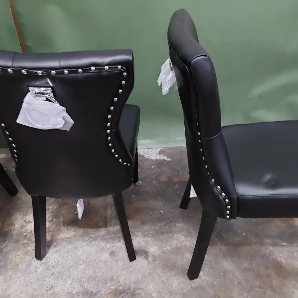 SET OF FOUR UPHOLSTERED BUTTONED RING BACK DINING CHAIRS BLACK PU WITH STUDDED DETAIL ON DARK WOOD 