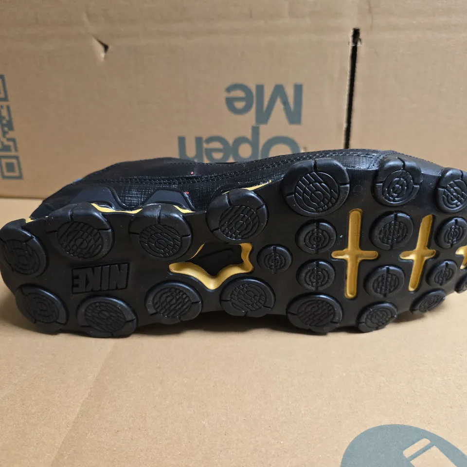 UNBOXED PAIR OF NIKE TRAINING REAX TRAINERS IN BLACK/GOLD - UK 8.5