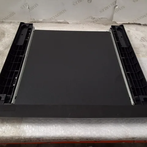 Black plastic chassis/slot component (Model WZXX90-BE B001-000) – likely peripheral