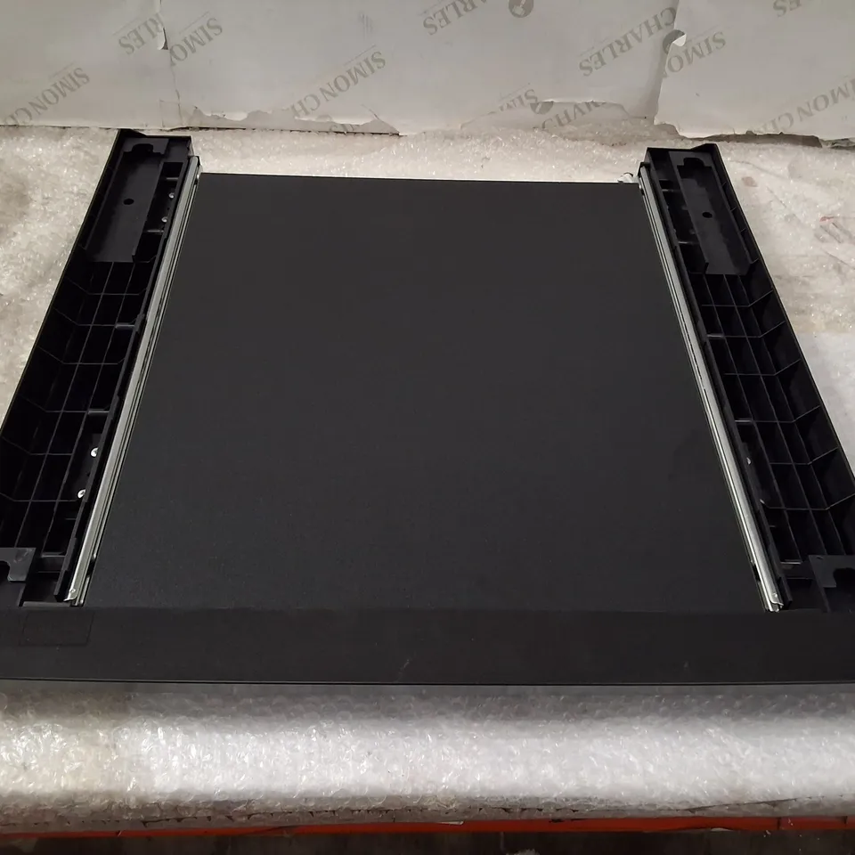 Black plastic chassis/slot component (Model WZXX90-BE B001-000) – likely peripheral