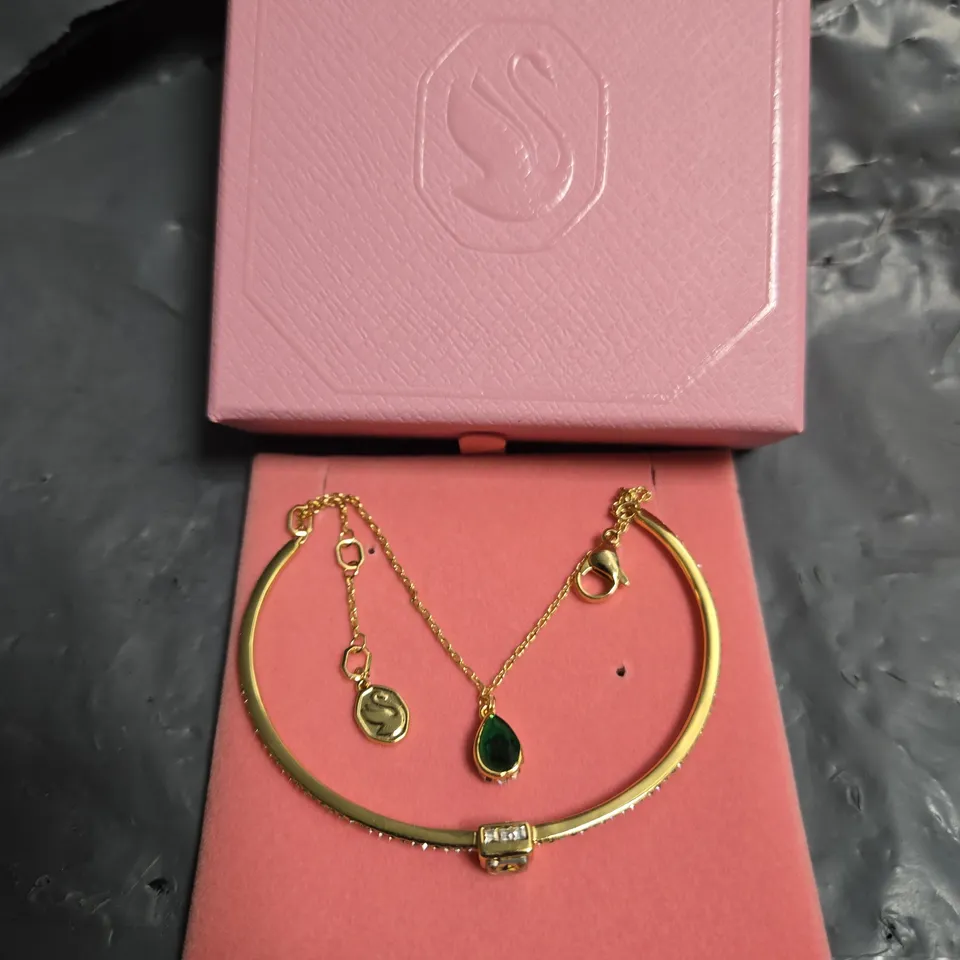 SWAROVSKI GOLD-TONE BRACELET AND PENDANT NECKLACE SET WITH EMERALD-GREEN GEMSTONE – BOXED