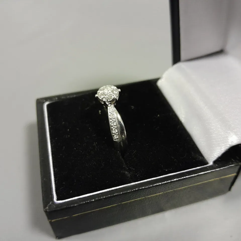 9CT WHITE GOLD RING WITH NATURAL DIAMOND HALO AND TWIST SHOULDERS