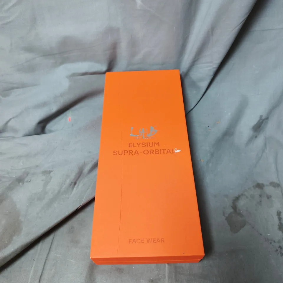 ELYSIUM SUPRA-ORBITAL FACE WEAR – WHITE MASK IN ORANGE BOX.