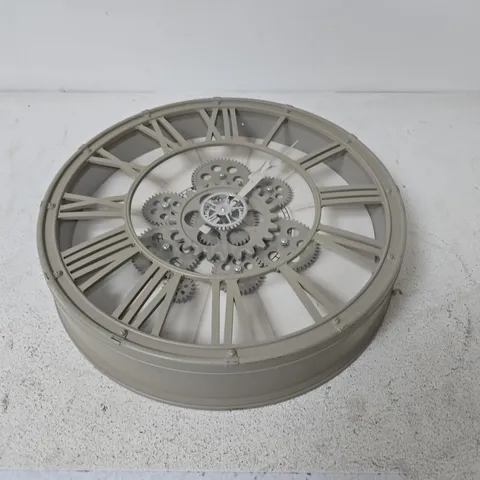 DECORATIVE WALL CLOCK WITH ROMAN NUMERALS AND EXPOSED GEARS