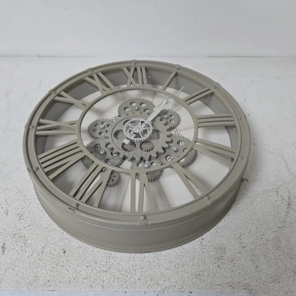 DECORATIVE WALL CLOCK WITH ROMAN NUMERALS AND EXPOSED GEARS