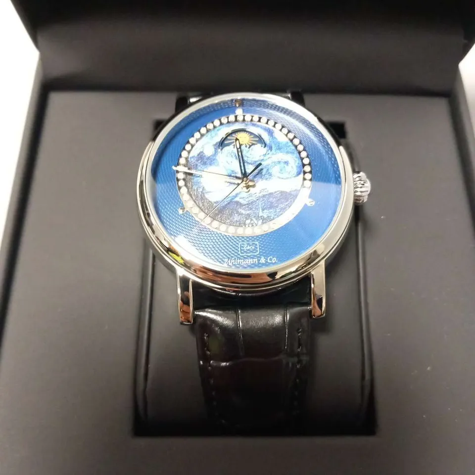 BOXED ZIHIMANN STAINLESS STEEL FRAMED WRIST WATCH WITH BLACK STRAPS AND DIAMANTE FRAMED IMAGERY