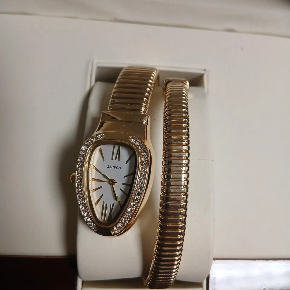 QUARTZ WATCH WITH STONE-SET BEZEL IN GOLD-TONE, BOXED