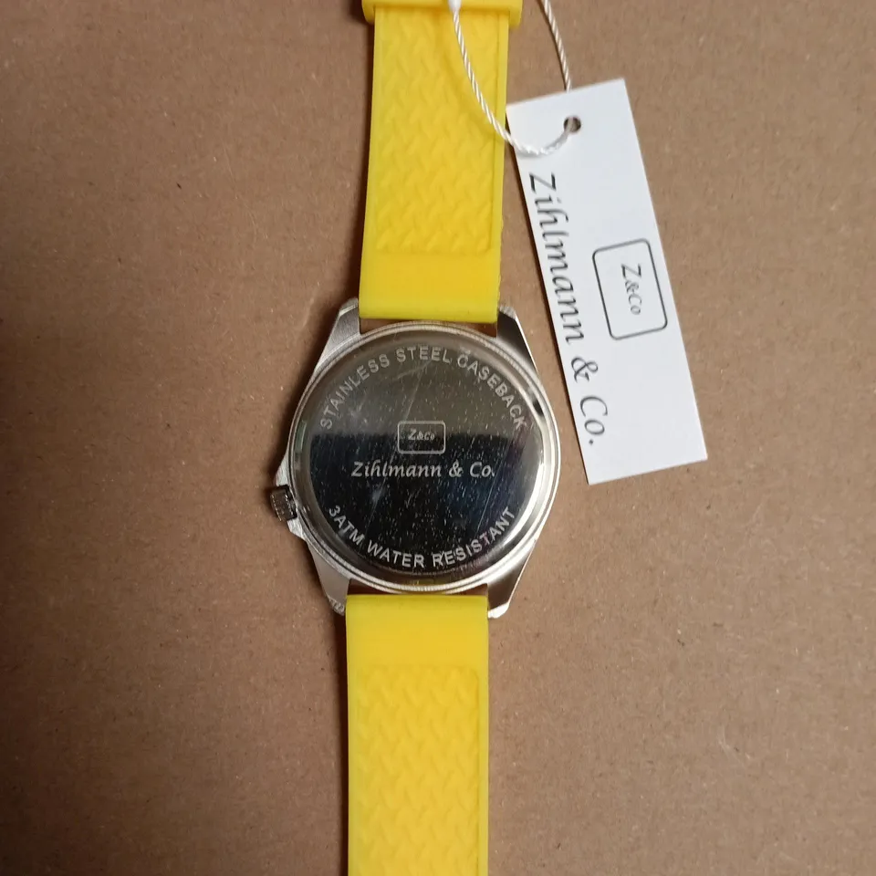 BOXED ZICHMANN & CO STAINLESS STEEL CASEBACK WATCH WITH YELLOW SILICONE STRAP