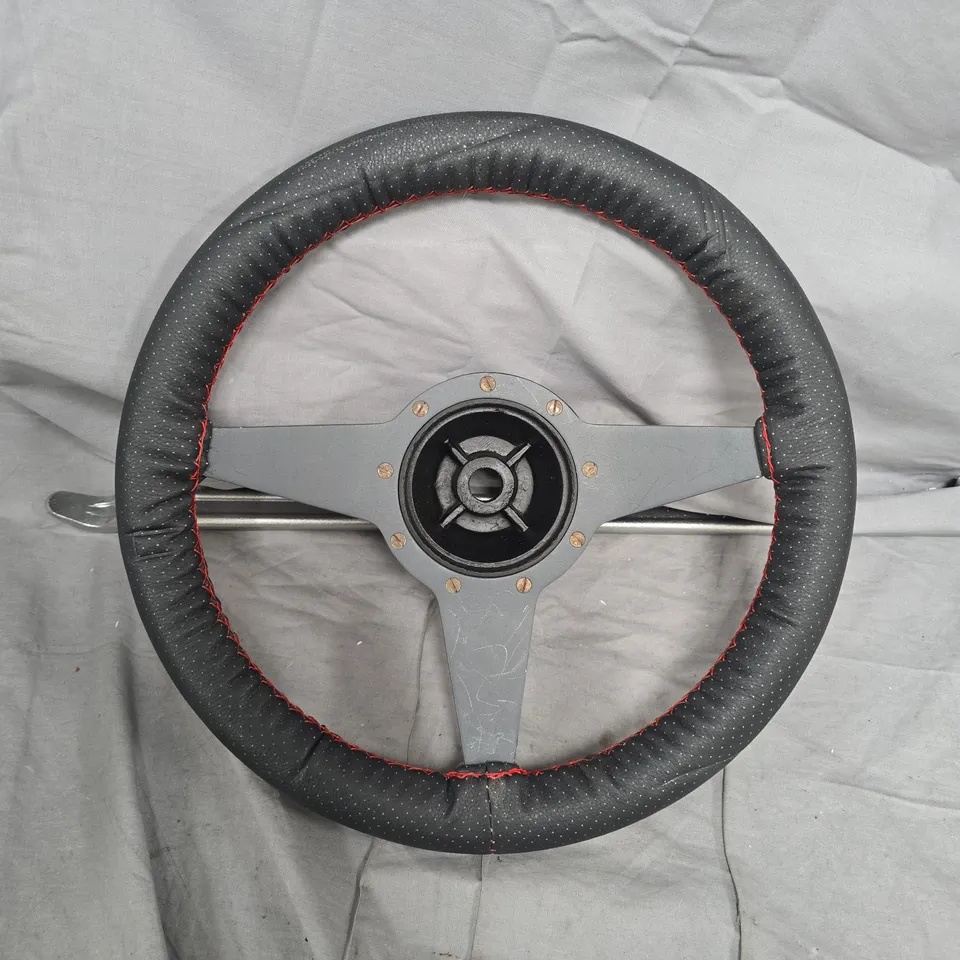 AFTERMARKET THREE-SPOKE STEERING WHEEL WITH GREY HUB – BLACK PERFORATED COVER, RED STITCHING   13.5 INC