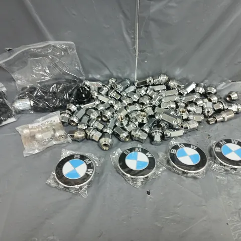 LARGE QUANTITY OF ASSORTED WHEEL LUGNUTS WITH 4 BMW WHEEL HUB CAPS